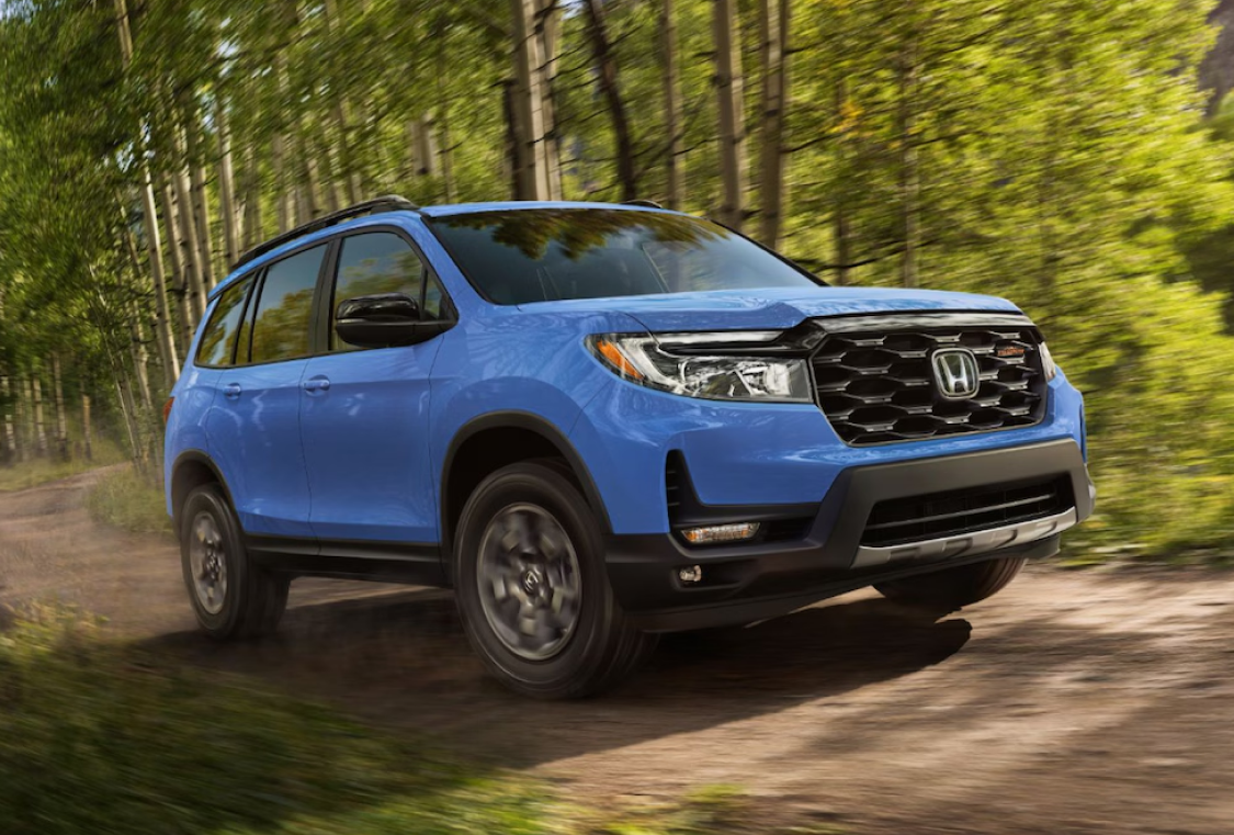 Honda SUV Driving on Gravel Road in the forest