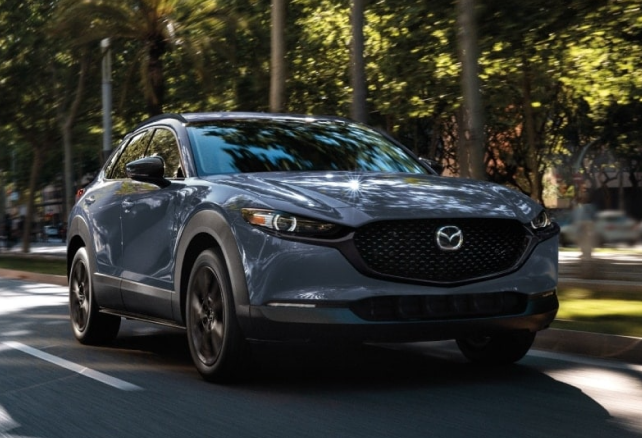Mazda driving through neighborhood roads