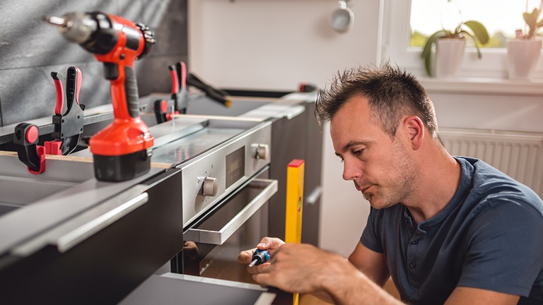 Employee remodeling kitchen for their client
