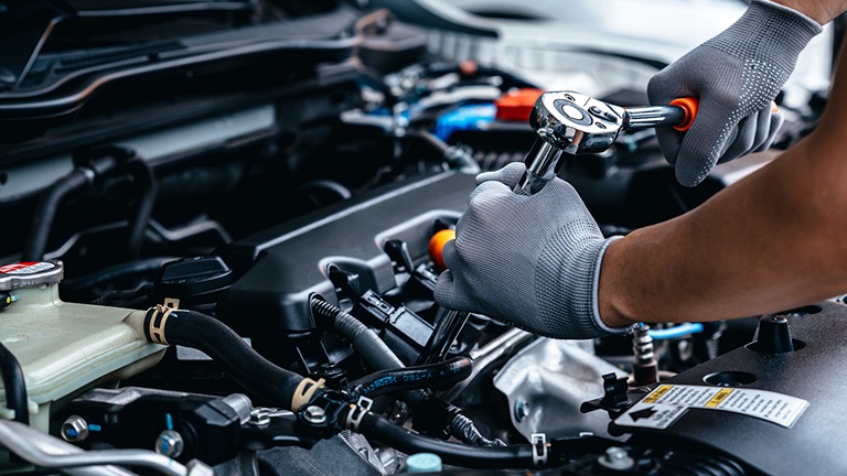 Mechanic servicing a vehicle's engine