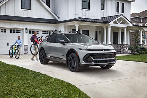 Chevrolet Equinox parked in a driveway in front of a house