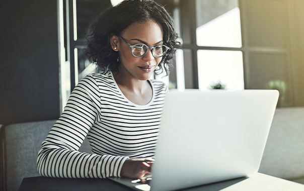 Woman using AI tools on computer to power the future