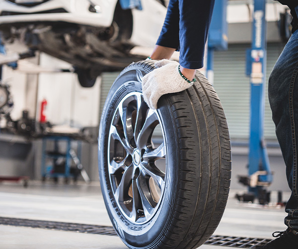 service tech holding a tire