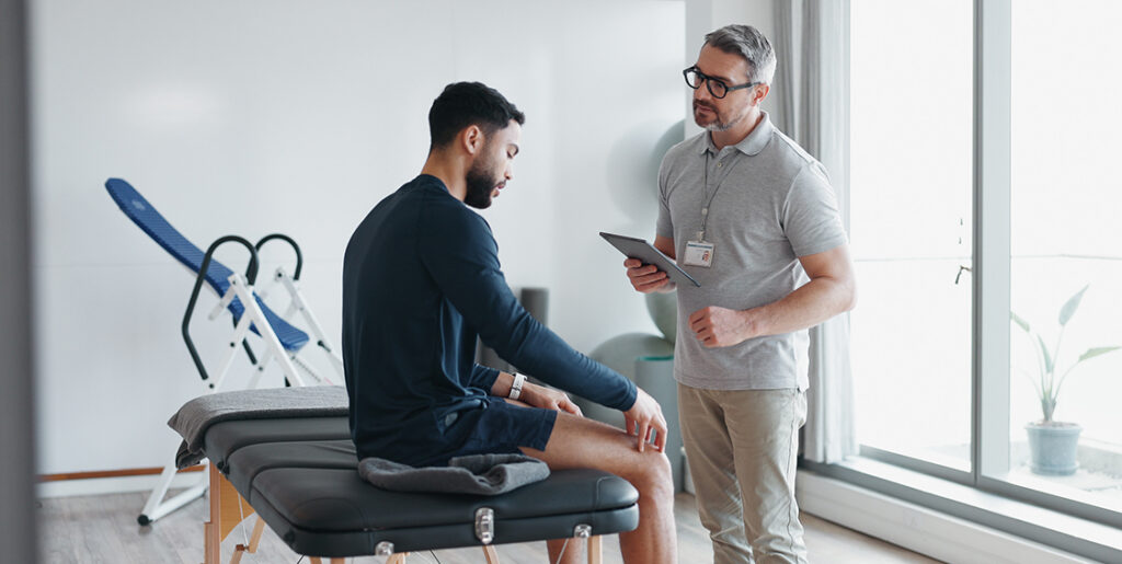 chiropractor talking with patient