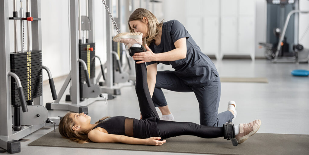 Physical therapist stretching a woman