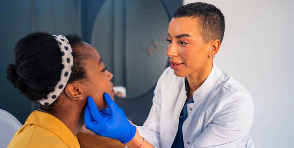 woman examining face